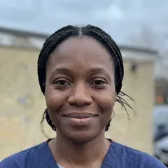 Grace Adeyemi in navy scrubs outside the hospital